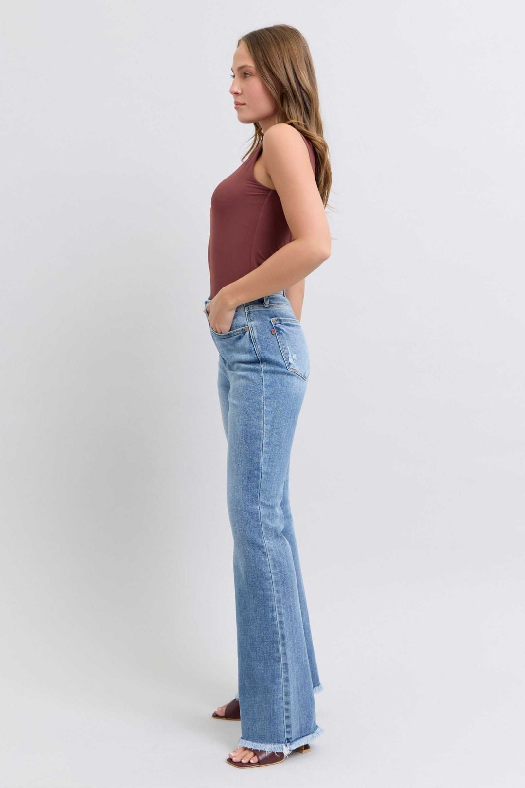 Judy Blue Raw Hem High Rise Bootcut JeansRaw hem high rise bootcut jeans are a trendy and stylish denim option for a fashionable look. These jeans typically feature a high-rise waist that sits above the natBootcut JeansJudy Blue Raw Hem