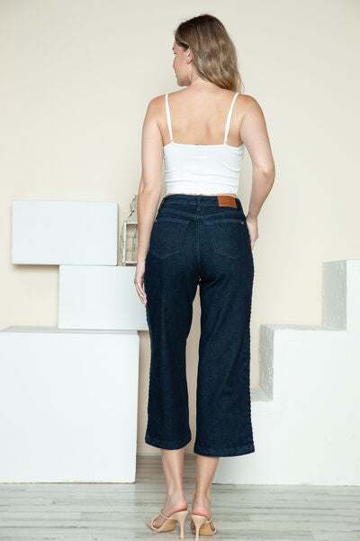 Judy Blue Side Seam Braid Detail Crop Wide Leg JeansThe High Rise side seam braid detail crop wide leg jeans offer a contemporary twist on classic denim. Featuring a unique braided detail along the side seams, these jCropped JeansJudy Blue Side Seam