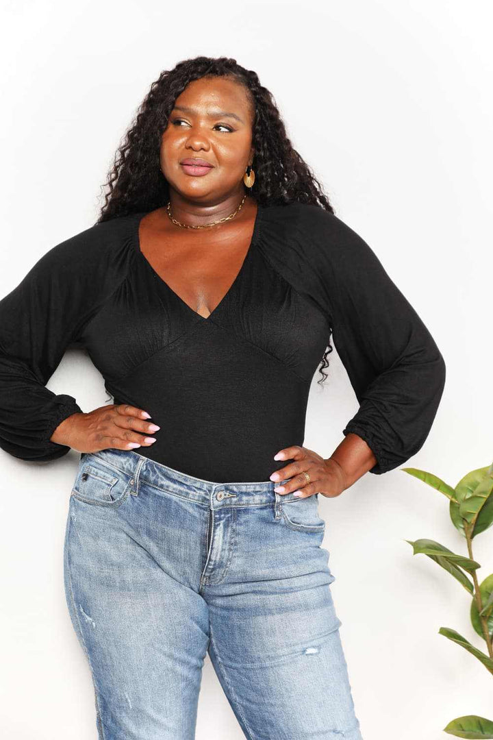 V- Neck Long Sleeve BodysuitThis bodysuit seamlessly merges romantic allure with contemporary flair. The poet sleeves, with their billowing and slightly puffed structure, infuse a sense of dramBodysuitsV- Neck Long Sleeve Bodysuit