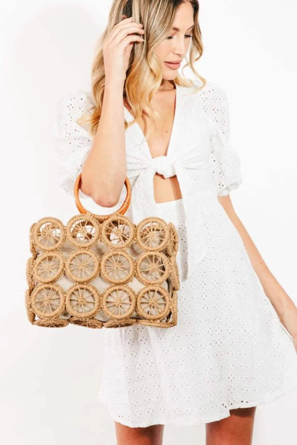 Fame Intricate Braided Wheels HandbagThe Intricate Braided Wheels Handbag is a stunning accessory designed with intricate braided detailing in the shape of wheels. This handbag exudes a unique and artisHandbagsFame Intricate Braided Wheels