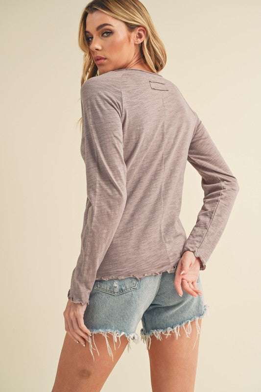 Cotton Lettuce Hem Long Sleeve T-ShirtThe Cotton Lettuce Hem Long Sleeve T-Shirt is a unique piece with a round neckline, raglan sleeves, and a lettuce hemline. This t-shirt features a fun and feminine dT-ShirtsCotton Lettuce Hem
