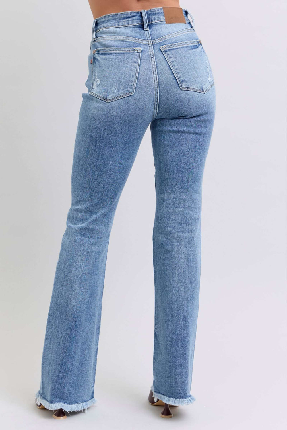 Judy Blue Raw Hem High Rise Bootcut JeansRaw hem high rise bootcut jeans are a trendy and stylish denim option for a fashionable look. These jeans typically feature a high-rise waist that sits above the natBootcut JeansJudy Blue Raw Hem