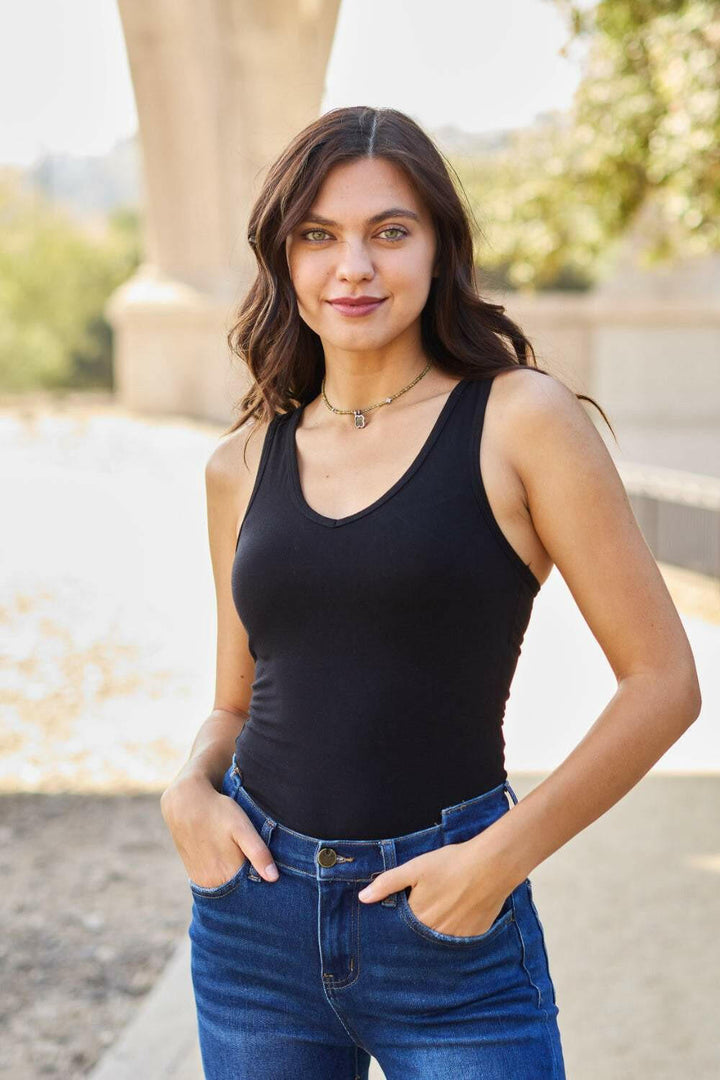 Racerback Tank BodysuitThis chic and flexible cotton blend bodysuit is meant to give you a perfect fit, hugging all the right curves. The racerback style adds a sporty flair, making it ideBodysuitsRacerback Tank Bodysuit