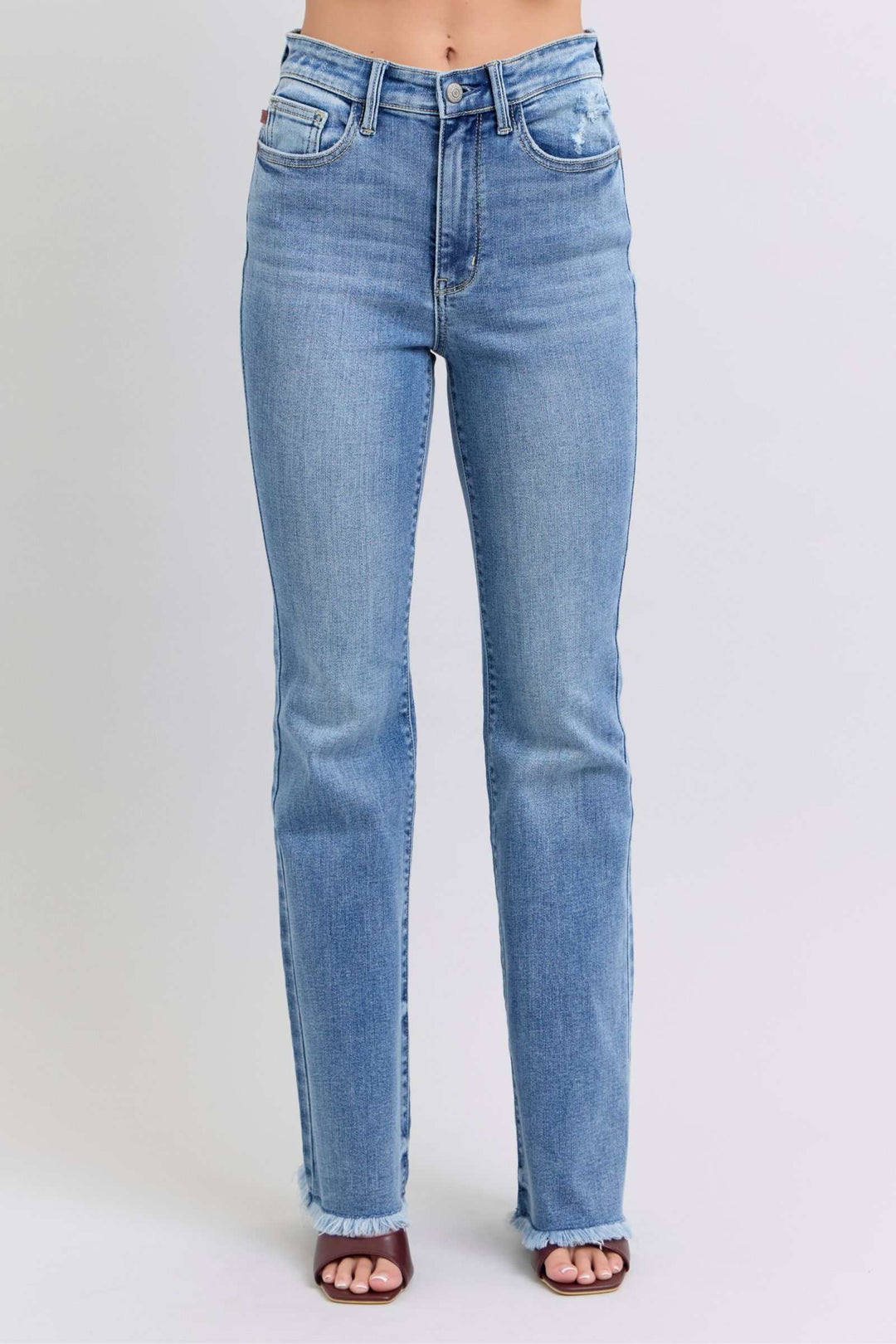Judy Blue Raw Hem High Rise Bootcut JeansRaw hem high rise bootcut jeans are a trendy and stylish denim option for a fashionable look. These jeans typically feature a high-rise waist that sits above the natBootcut JeansJudy Blue Raw Hem