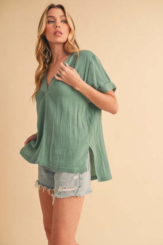 Textured Cotton V-Neck Short Sleeve BlouseThe Side Slit V-Neck Short Sleeve Blouse is a chic and modern top that combines style with a hint of sophistication. The V-neckline adds a flattering touch to the neShort Sleeve BlousesTextured Cotton V-Neck