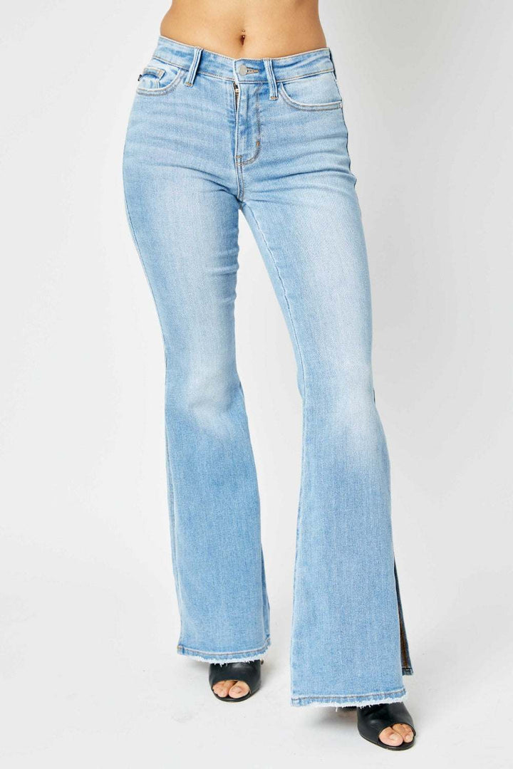 Judy Blue Mid Rise Raw Hem Slit Flare JeansThese jeans offer a flattering silhouette that hugs your curves in all the right places while providing a relaxed, retro-inspired flare at the hem. The versatile ligFlare JeansJudy Blue Mid Rise