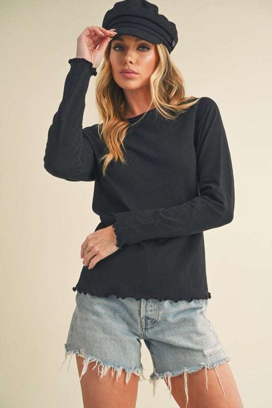 Cotton Lettuce Hem Long Sleeve T-ShirtThe Cotton Lettuce Hem Long Sleeve T-Shirt is a unique piece with a round neckline, raglan sleeves, and a lettuce hemline. This t-shirt features a fun and feminine dT-ShirtsCotton Lettuce Hem