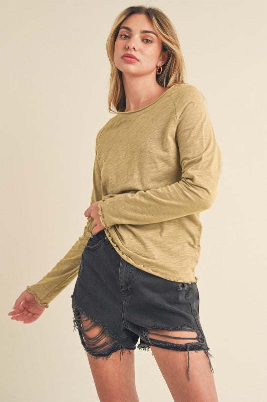 Cotton Lettuce Hem Long Sleeve T-ShirtThe Cotton Lettuce Hem Long Sleeve T-Shirt is a unique piece with a round neckline, raglan sleeves, and a lettuce hemline. This t-shirt features a fun and feminine dT-ShirtsCotton Lettuce Hem