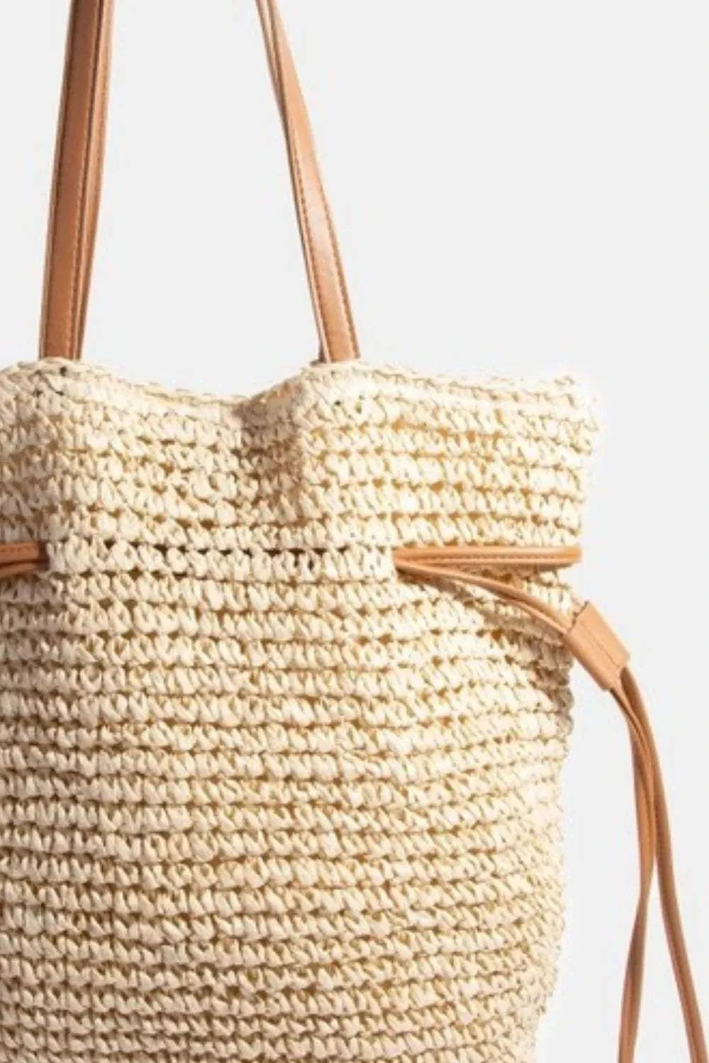 Fame Faux Leather Straps Braided Tote BagThis faux leather straps braided tote bag is a sophisticated and stylish accessory that adds a touch of elegance to any ensemble. The combination of faux leather andTote BagsFame Faux Leather