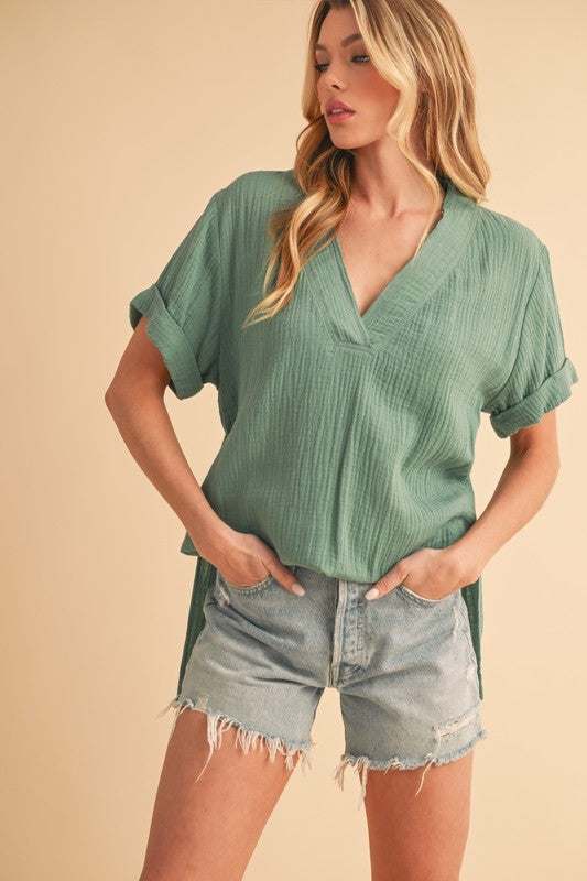 Textured Cotton V-Neck Short Sleeve BlouseThe Side Slit V-Neck Short Sleeve Blouse is a chic and modern top that combines style with a hint of sophistication. The V-neckline adds a flattering touch to the neShort Sleeve BlousesTextured Cotton V-Neck