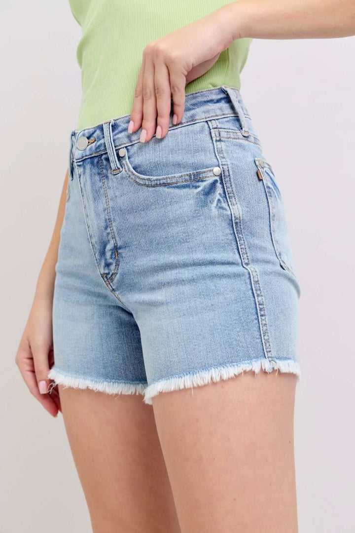 Judy Blue Tummy Control Raw Hem Denim ShortsThe tummy control raw hem denim shorts are designed to provide a slimming effect around the waist area while also featuring a trendy raw hem finish at the bottom. ThJean ShortsJudy Blue Tummy Control