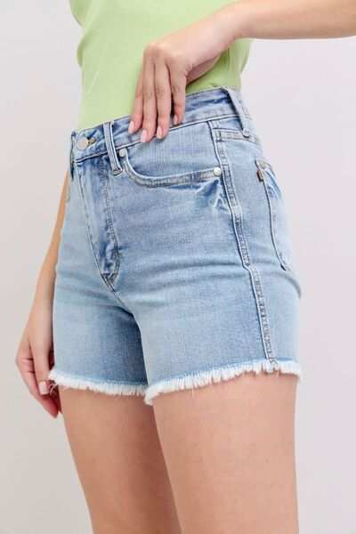 Judy Blue Tummy Control Raw Hem Denim ShortsThe tummy control raw hem denim shorts are designed to provide a slimming effect around the waist area while also featuring a trendy raw hem finish at the bottom. ThJean ShortsJudy Blue Tummy Control