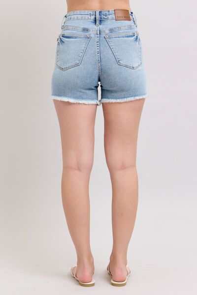 Judy Blue Tummy Control Raw Hem Denim ShortsThe tummy control raw hem denim shorts are designed to provide a slimming effect around the waist area while also featuring a trendy raw hem finish at the bottom. ThJean ShortsJudy Blue Tummy Control