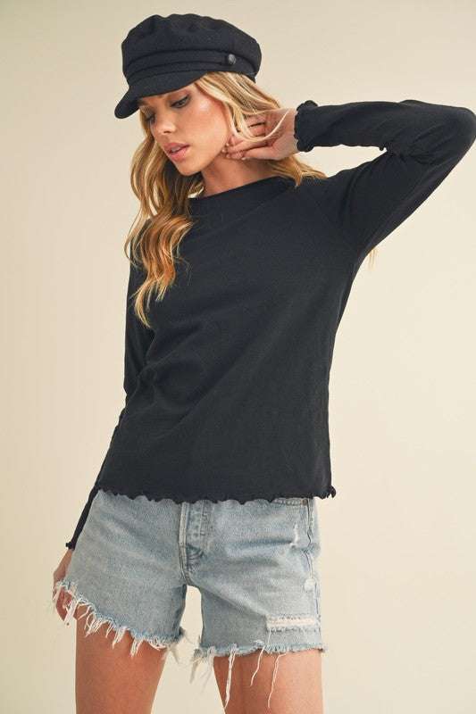 Cotton Lettuce Hem Long Sleeve T-ShirtThe Cotton Lettuce Hem Long Sleeve T-Shirt is a unique piece with a round neckline, raglan sleeves, and a lettuce hemline. This t-shirt features a fun and feminine dT-ShirtsCotton Lettuce Hem