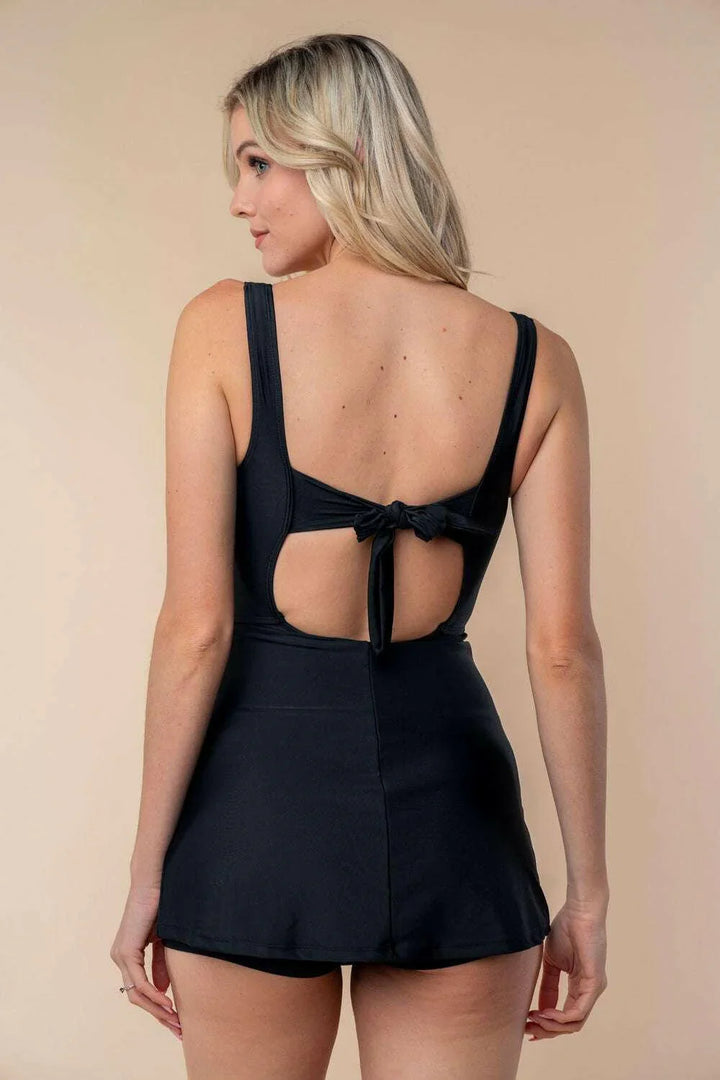 Performance Knit Swim DressMake a splash in style with this sleeveless solid knit swim dress, designed with a scoop neck, front keyhole, and back self-tie for a touch of elegance. Crafted fromOne Piece SwimwearPerformance Knit Swim Dress