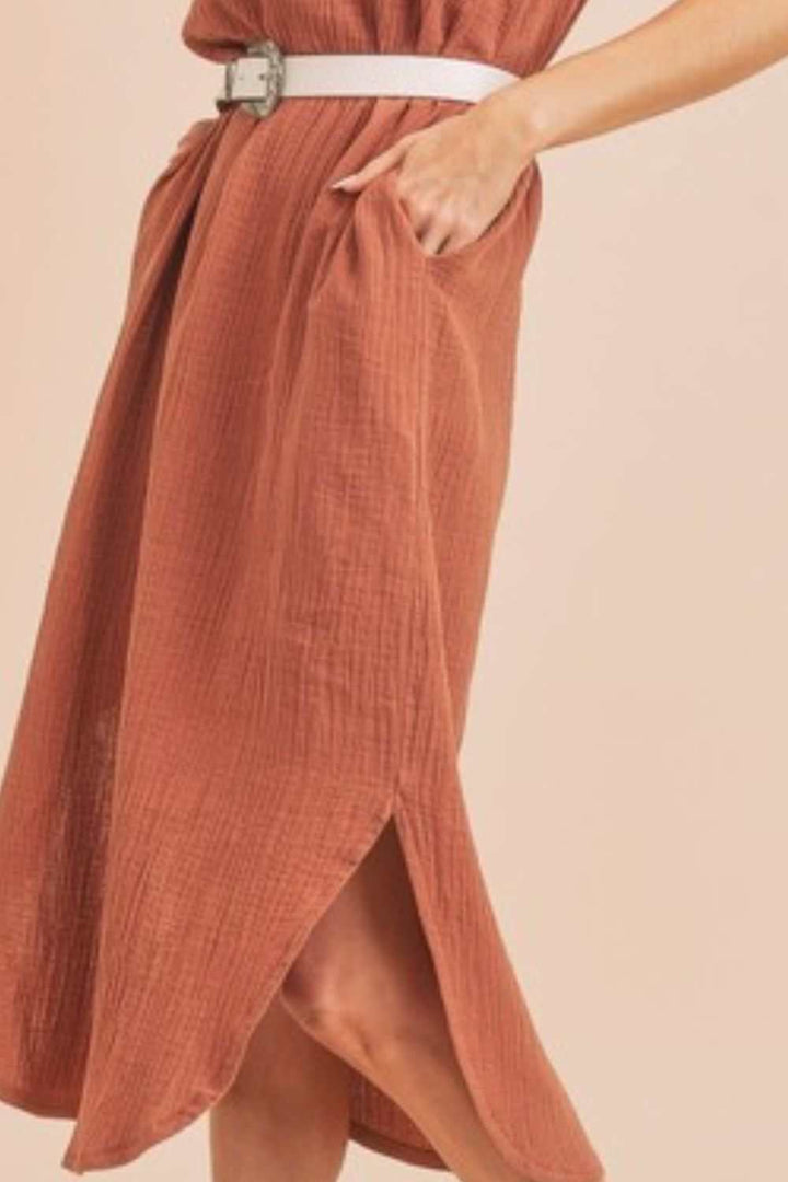 Textured Cotton Midi Tank Dress with PocketsA round neck midi tank dress with pockets is a sleeveless dress that features a round neckline and practical pockets on the dress. This type of dress is casual and cMidi DressesTextured Cotton Midi