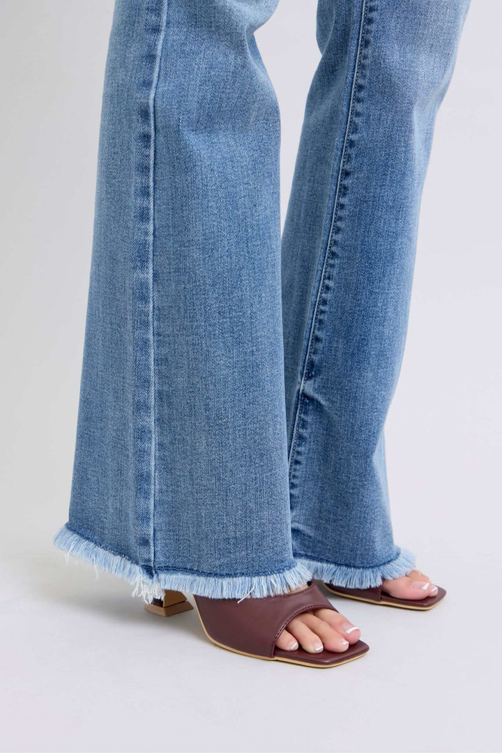Judy Blue Raw Hem High Rise Bootcut JeansRaw hem high rise bootcut jeans are a trendy and stylish denim option for a fashionable look. These jeans typically feature a high-rise waist that sits above the natBootcut JeansJudy Blue Raw Hem