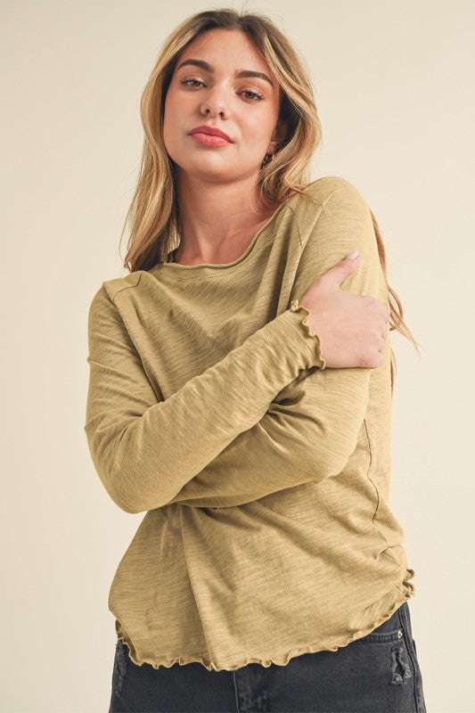 Cotton Lettuce Hem Long Sleeve T-ShirtThe Cotton Lettuce Hem Long Sleeve T-Shirt is a unique piece with a round neckline, raglan sleeves, and a lettuce hemline. This t-shirt features a fun and feminine dT-ShirtsCotton Lettuce Hem