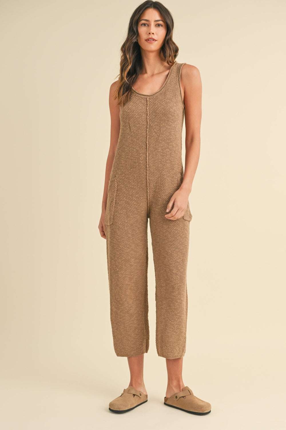Cotton Knit JumpsuitThis sleeveless 100% cotton knit crop jumpsuit is crafted from a textured sweater knit material, offering both style and comfort. The side pocket detail adds functioJumpsuitsCotton Knit Jumpsuit