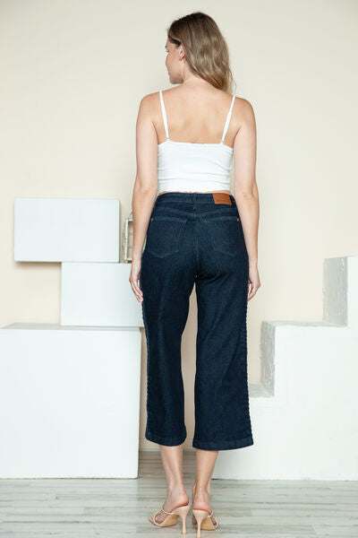 Judy Blue Side Seam Braid Detail Crop Wide Leg JeansThe High Rise side seam braid detail crop wide leg jeans offer a contemporary twist on classic denim. Featuring a unique braided detail along the side seams, these jCropped JeansJudy Blue Side Seam