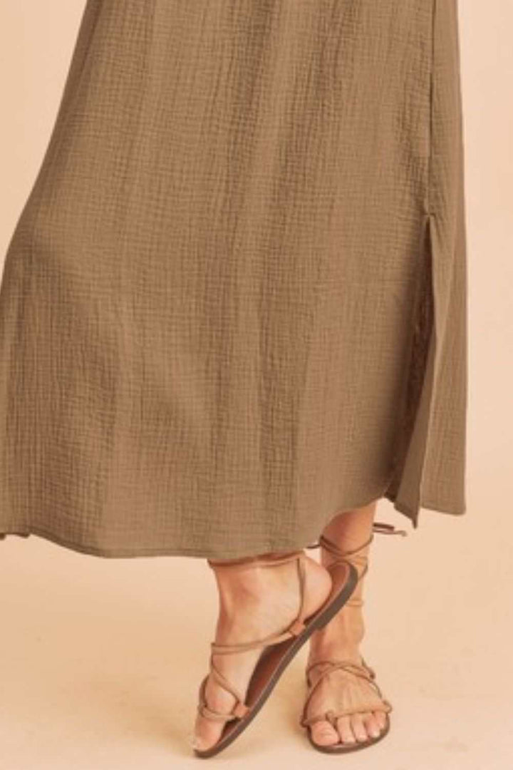 The Textured Cotton Midi Tank DressLight, breathable, and softly structured, The Textured Midi Tank Dress is crafted from a gently textured cotton that moves with ease. The sleeveless tank silhouette Midi DressesTextured Cotton Midi Tank