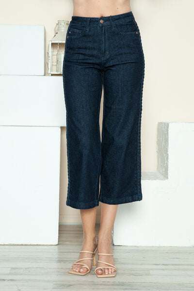 Judy Blue Side Seam Braid Detail Crop Wide Leg JeansThe High Rise side seam braid detail crop wide leg jeans offer a contemporary twist on classic denim. Featuring a unique braided detail along the side seams, these jCropped JeansJudy Blue Side Seam