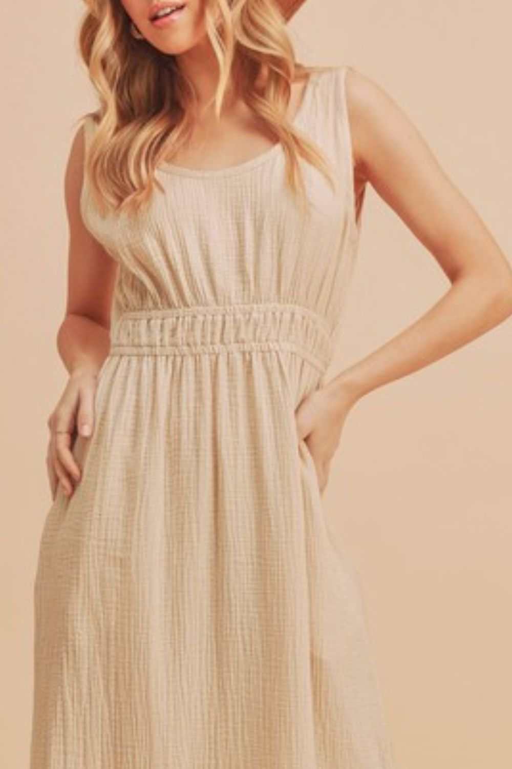 The Textured Cotton Midi Tank DressLight, breathable, and softly structured, The Textured Midi Tank Dress is crafted from a gently textured cotton that moves with ease. The sleeveless tank silhouette Midi DressesThe Textured Cotton Midi Tank Dress