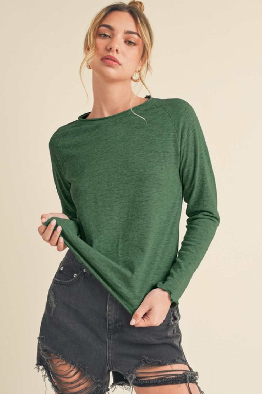 Cotton Lettuce Hem Long Sleeve T-ShirtThe Cotton Lettuce Hem Long Sleeve T-Shirt is a unique piece with a round neckline, raglan sleeves, and a lettuce hemline. This t-shirt features a fun and feminine dT-ShirtsCotton Lettuce Hem