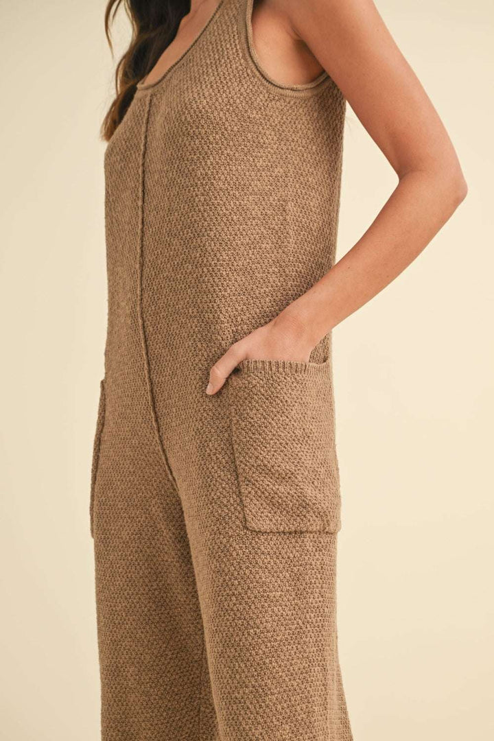 Cotton Knit JumpsuitThis sleeveless 100% cotton knit crop jumpsuit is crafted from a textured sweater knit material, offering both style and comfort. The side pocket detail adds functioJumpsuitsCotton Knit Jumpsuit
