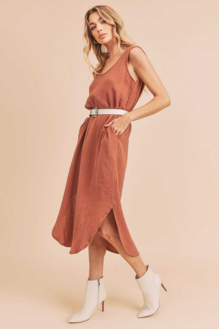 Textured Cotton Midi Tank Dress with PocketsA round neck midi tank dress with pockets is a sleeveless dress that features a round neckline and practical pockets on the dress. This type of dress is casual and cMidi DressesTextured Cotton Midi