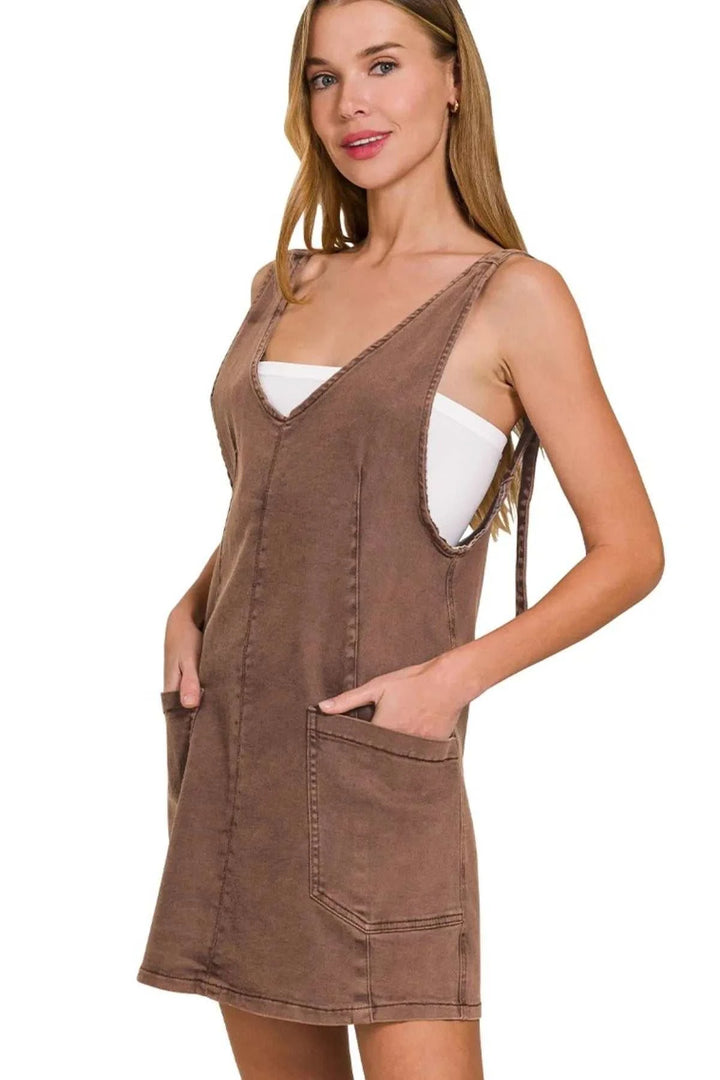Washed Adjustable Strap Denim Overall DressThis stylish denim dress features a soft coffee washed denim construction with a relaxed, comfortable fit. The deep V-neckline and sleeveless design make it perfect Mini DressesWashed Adjustable Strap
