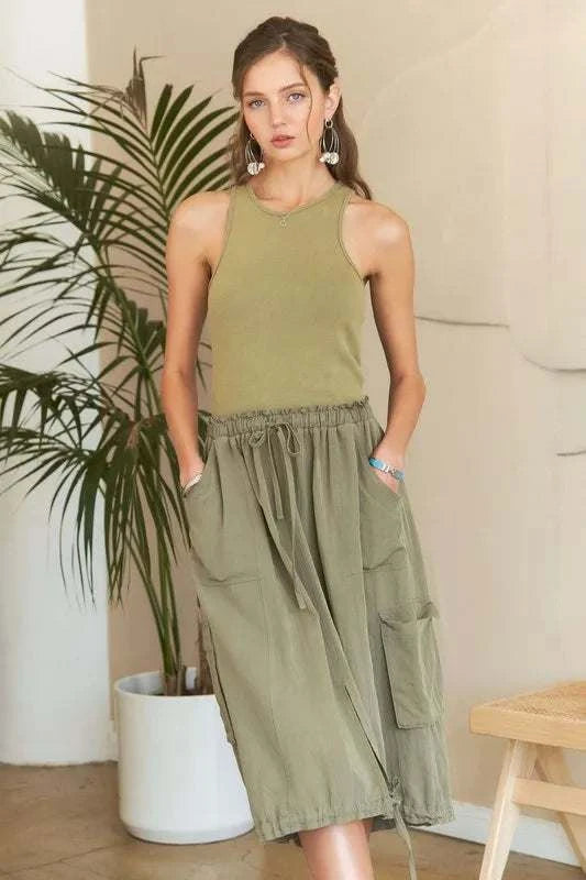 Drawstring Sleeveless Washed DressThe Drawstring Sleeveless Washed Dress is a casual yet stylish piece for everyday wear. With its sleeveless design and relaxed silhouette, this dress offers both comMidi DressesDrawstring Sleeveless Dress