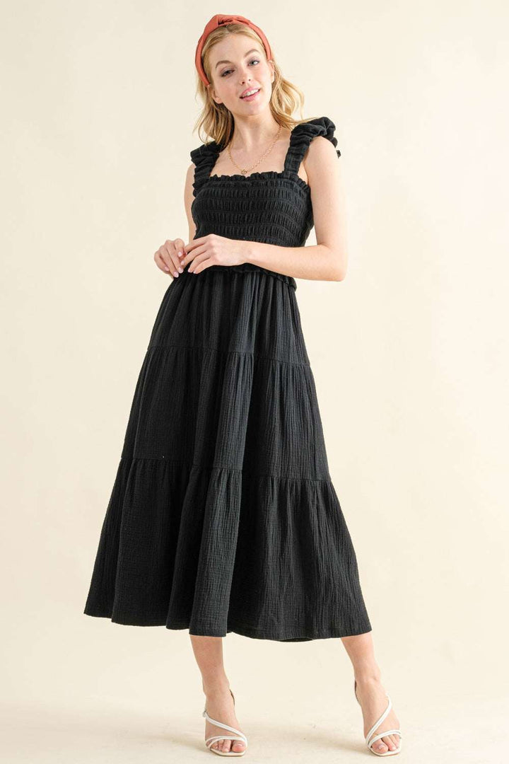 Smocked Ruffled Tiered DressThe Smocked Ruffled Tiered Dress is a charming and feminine 100% cotton piece that exudes effortless style. The smocked bodice provides a comfortable and flattering Midi DressesSmocked Ruffled Tiered Dress