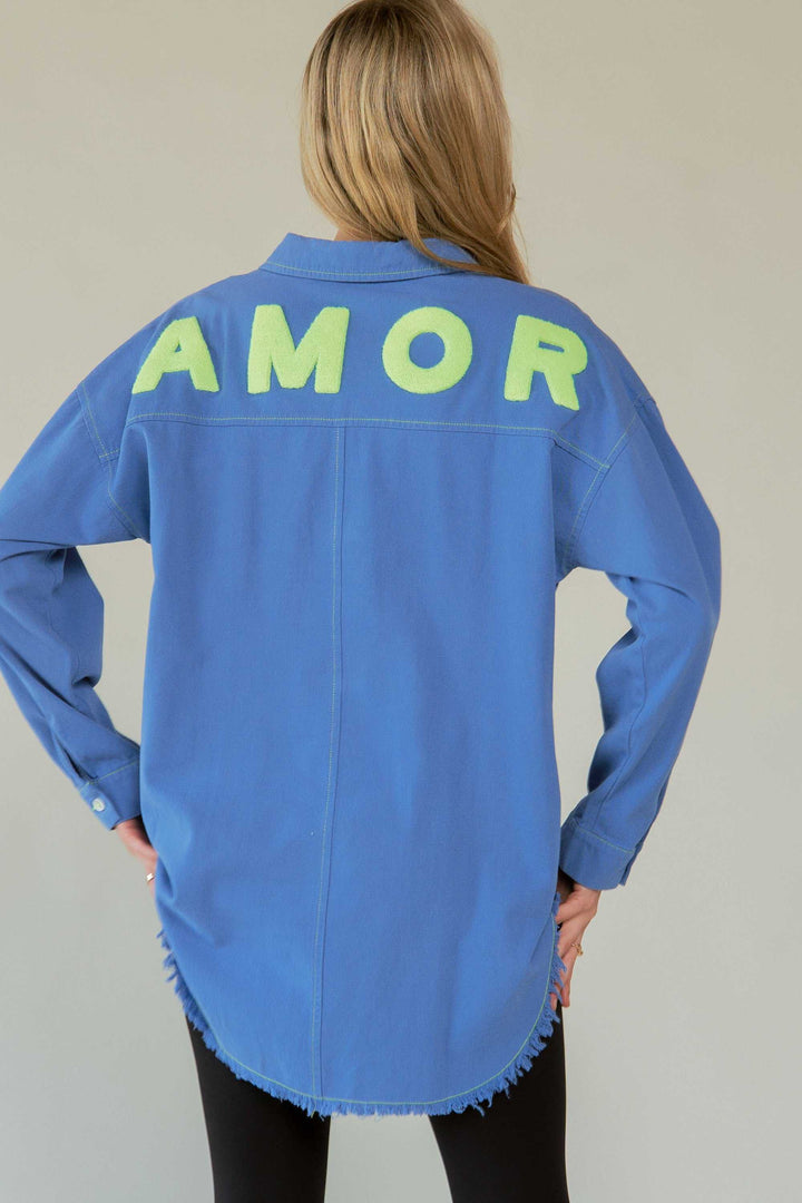 Amor Oversized ShirtLove in every stitch. This oversized 100% cotton button-up shirt features a bold "AMOR" appliqué across the back in plush lettering, adding a playful statement to yoButton-Up ShirtsAmor Oversized Shirt