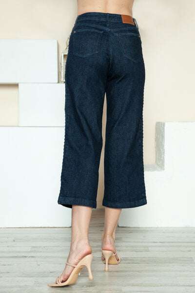 Judy Blue Side Seam Braid Detail Crop Wide Leg JeansThe High Rise side seam braid detail crop wide leg jeans offer a contemporary twist on classic denim. Featuring a unique braided detail along the side seams, these jCropped JeansJudy Blue Side Seam