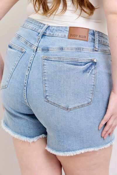 Judy Blue Tummy Control Raw Hem Denim ShortsThe tummy control raw hem denim shorts are designed to provide a slimming effect around the waist area while also featuring a trendy raw hem finish at the bottom. ThJean ShortsJudy Blue Tummy Control
