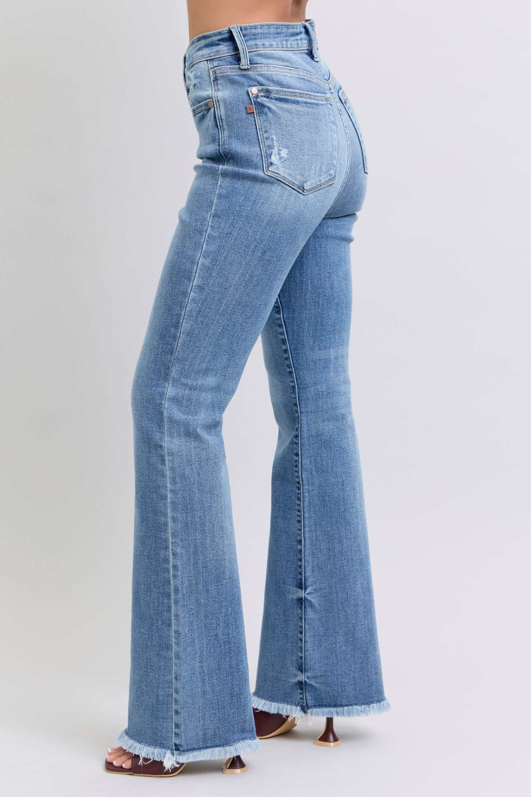 Judy Blue Raw Hem High Rise Bootcut JeansRaw hem high rise bootcut jeans are a trendy and stylish denim option for a fashionable look. These jeans typically feature a high-rise waist that sits above the natBootcut JeansJudy Blue Raw Hem