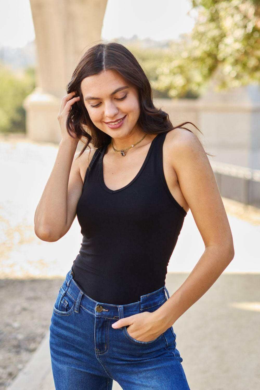 Racerback Tank BodysuitThis chic and flexible cotton blend bodysuit is meant to give you a perfect fit, hugging all the right curves. The racerback style adds a sporty flair, making it ideBodysuitsRacerback Tank Bodysuit