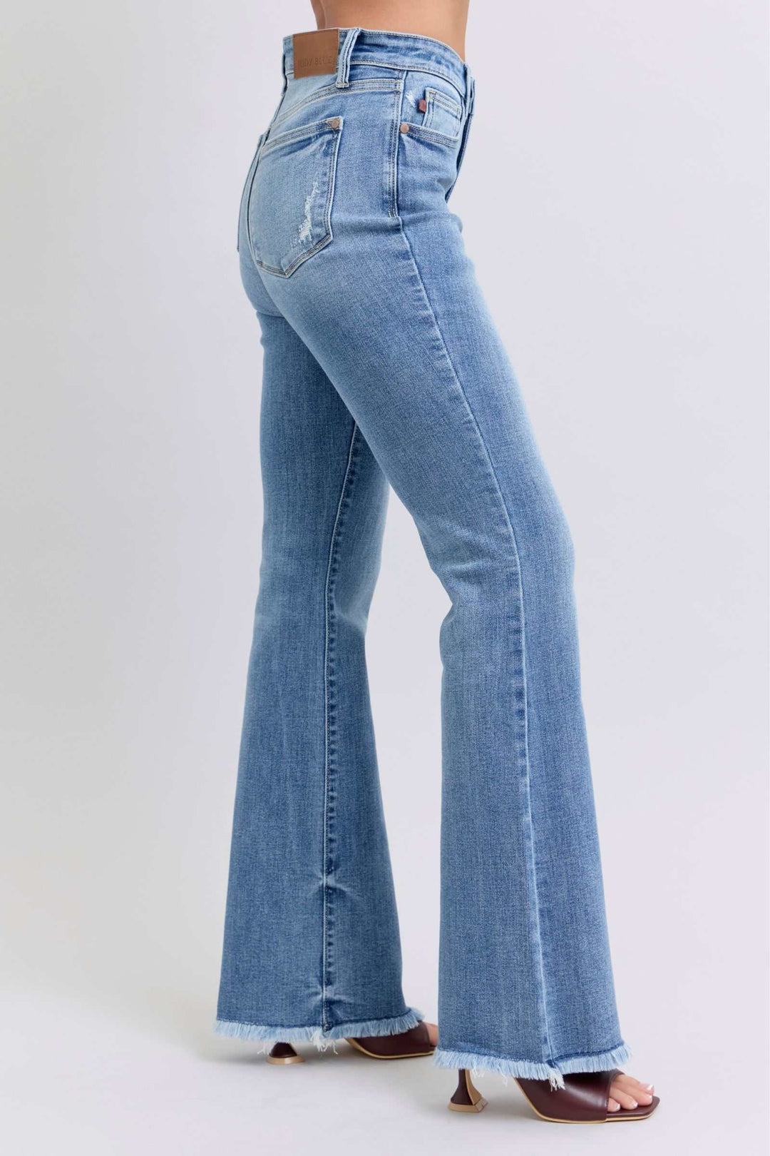 Judy Blue Raw Hem High Rise Bootcut JeansRaw hem high rise bootcut jeans are a trendy and stylish denim option for a fashionable look. These jeans typically feature a high-rise waist that sits above the natBootcut JeansJudy Blue Raw Hem