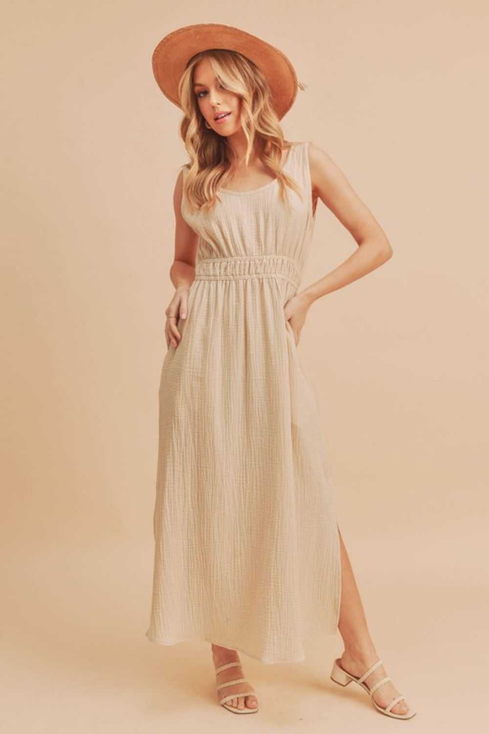 The Textured Cotton Midi Tank DressLight, breathable, and softly structured, The Textured Midi Tank Dress is crafted from a gently textured cotton that moves with ease. The sleeveless tank silhouette Midi DressesThe Textured Cotton Midi Tank Dress