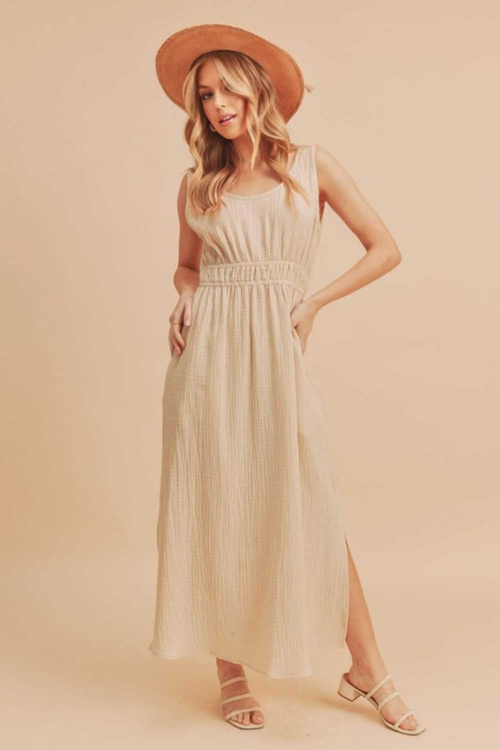 The Textured Cotton Midi Tank DressLight, breathable, and softly structured, The Textured Midi Tank Dress is crafted from a gently textured cotton that moves with ease. The sleeveless tank silhouette Midi DressesThe Textured Cotton Midi Tank Dress