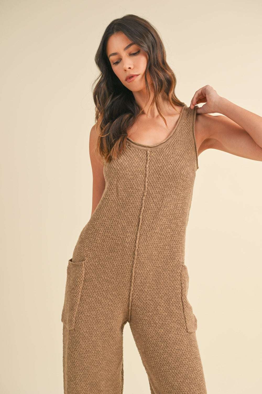 Cotton Knit JumpsuitThis sleeveless 100% cotton knit crop jumpsuit is crafted from a textured sweater knit material, offering both style and comfort. The side pocket detail adds functioJumpsuitsCotton Knit Jumpsuit