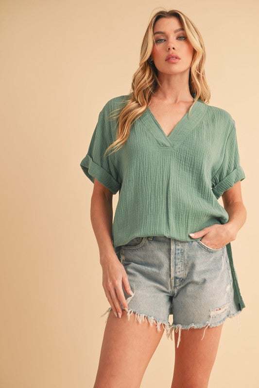 Textured Cotton V-Neck Short Sleeve BlouseThe Side Slit V-Neck Short Sleeve Blouse is a chic and modern top that combines style with a hint of sophistication. The V-neckline adds a flattering touch to the neShort Sleeve BlousesTextured Cotton V-Neck