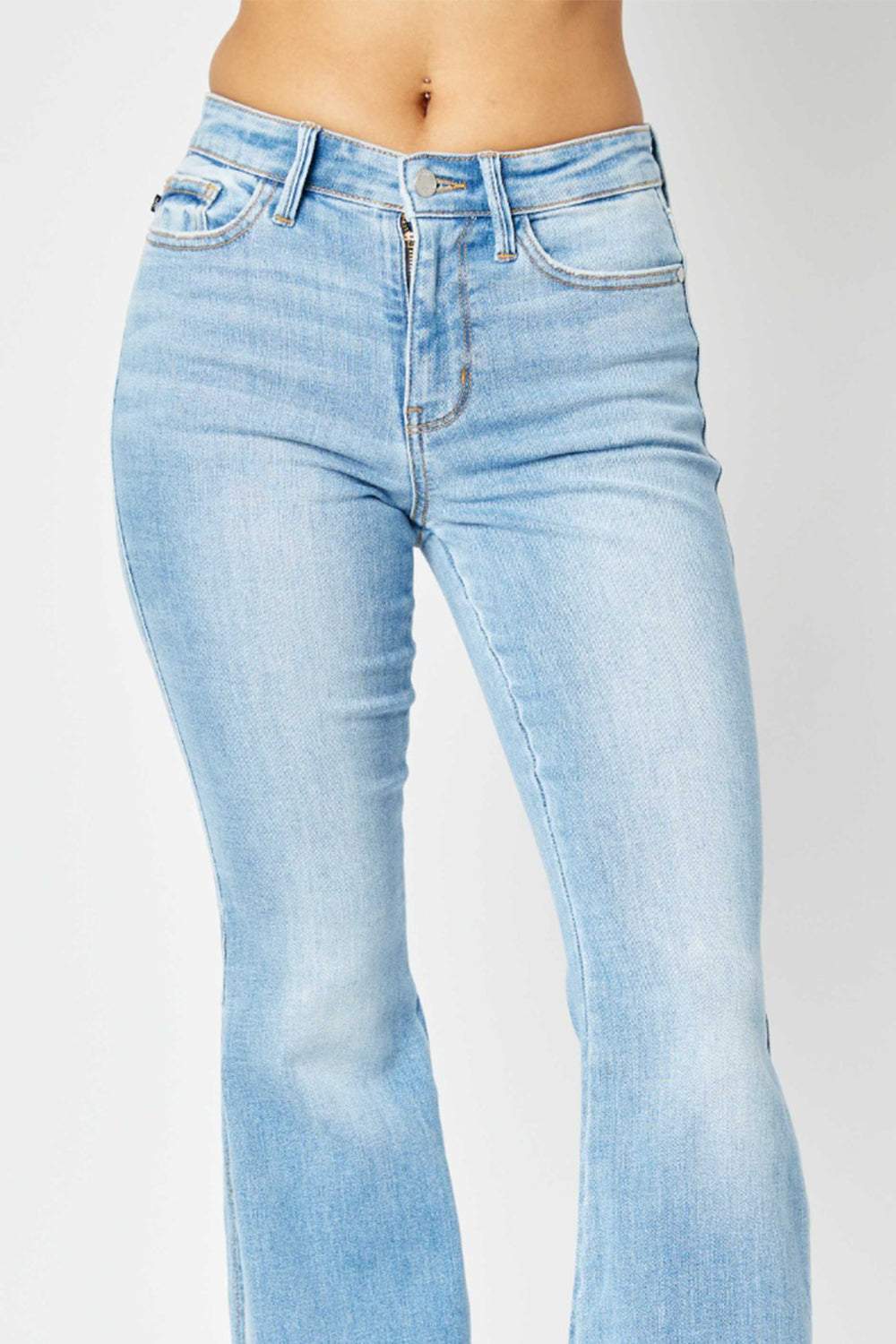 Judy Blue Mid Rise Raw Hem Slit Flare JeansThese jeans offer a flattering silhouette that hugs your curves in all the right places while providing a relaxed, retro-inspired flare at the hem. The versatile ligFlare JeansJudy Blue Mid Rise