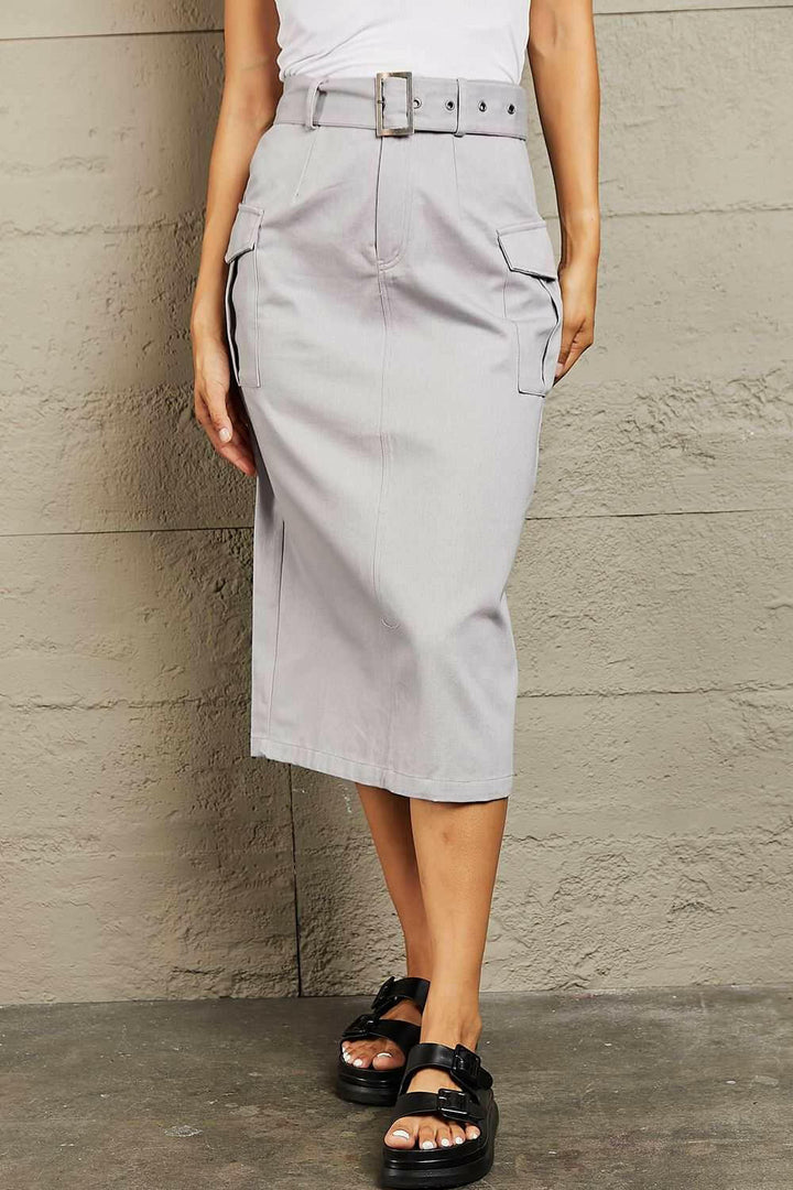 'Professional Poise' Buckled Cargo SkirtThis midi silhouette skirt boasts a flattering high waist that beautifully accentuates your curves. The adjustable buckled belt adds a touch of edginess to your lookMidi SkirtsBuckled Cargo Skirt