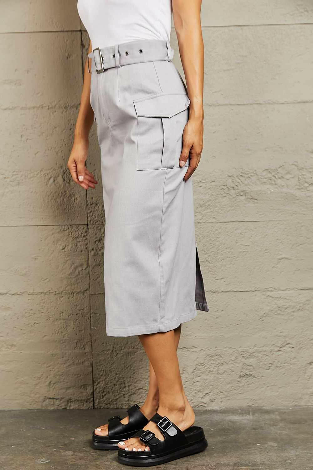 'Professional Poise' Buckled Cargo SkirtThis midi silhouette skirt boasts a flattering high waist that beautifully accentuates your curves. The adjustable buckled belt adds a touch of edginess to your lookMidi SkirtsBuckled Cargo Skirt