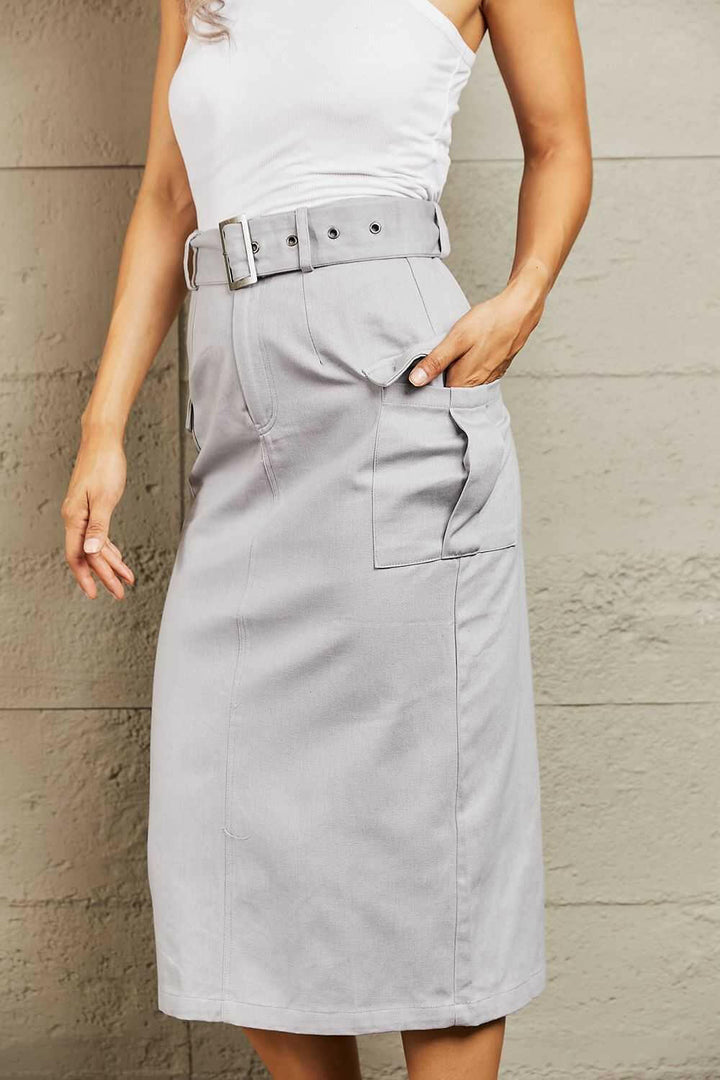 'Professional Poise' Buckled Cargo SkirtThis midi silhouette skirt boasts a flattering high waist that beautifully accentuates your curves. The adjustable buckled belt adds a touch of edginess to your lookMidi SkirtsBuckled Cargo Skirt
