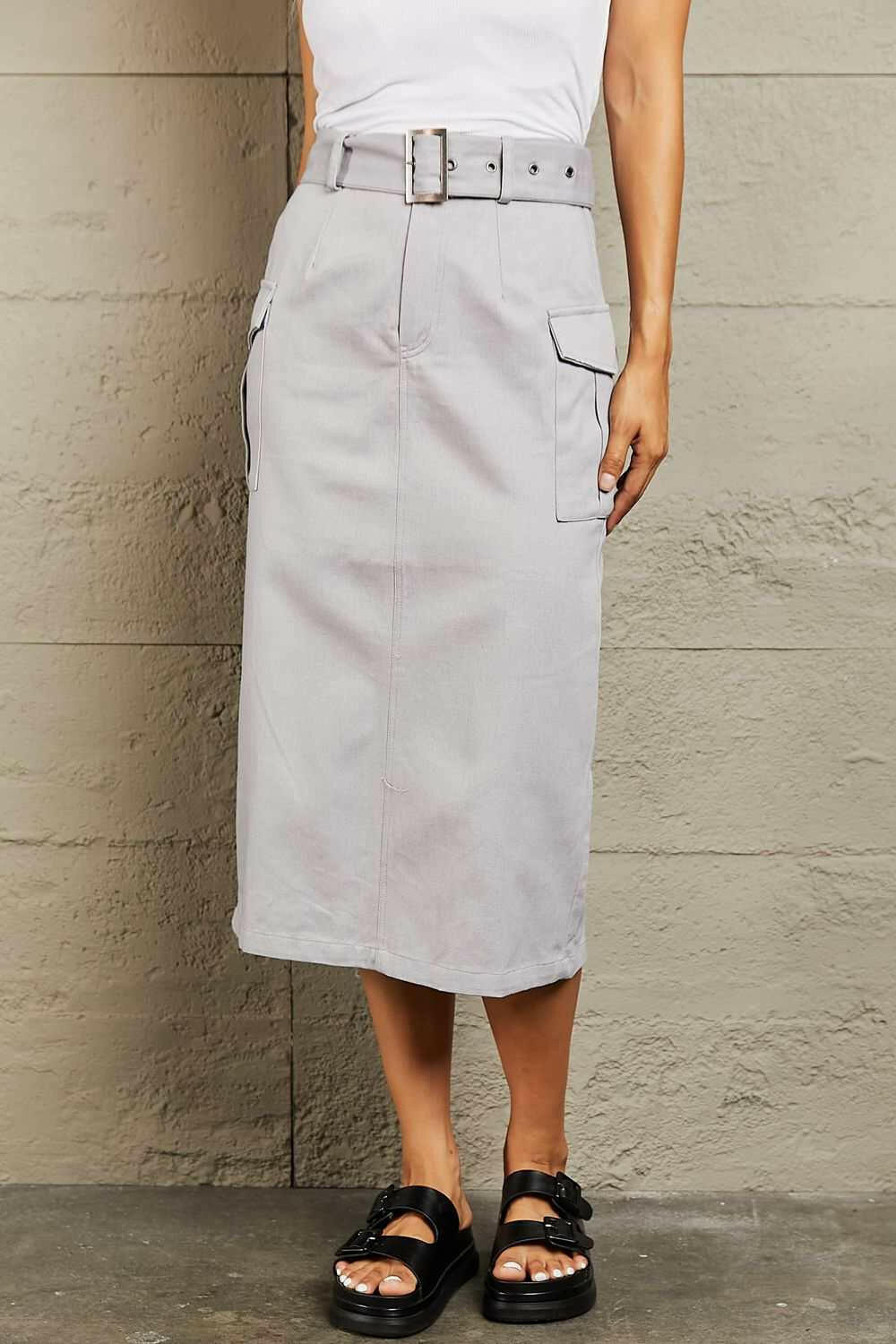 'Professional Poise' Buckled Cargo SkirtThis midi silhouette skirt boasts a flattering high waist that beautifully accentuates your curves. The adjustable buckled belt adds a touch of edginess to your lookMidi SkirtsBuckled Cargo Skirt