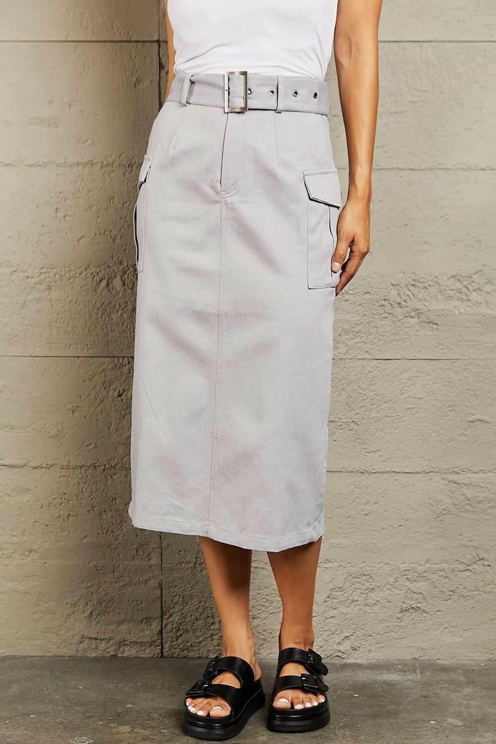 'Professional Poise' Buckled Cargo SkirtThis midi silhouette skirt boasts a flattering high waist that beautifully accentuates your curves. The adjustable buckled belt adds a touch of edginess to your lookMidi SkirtsBuckled Cargo Skirt