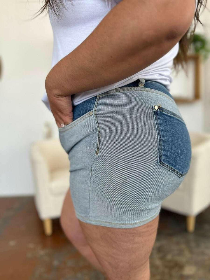 Judy Blue Color Block Denim ShortsStep into summer with an exclusive touch of modern flair featuring the Judy Blue Color Block Denim Shorts. Designed for trendsetters who demand both style and comforJean ShortsJudy Blue Color Block Denim Shorts